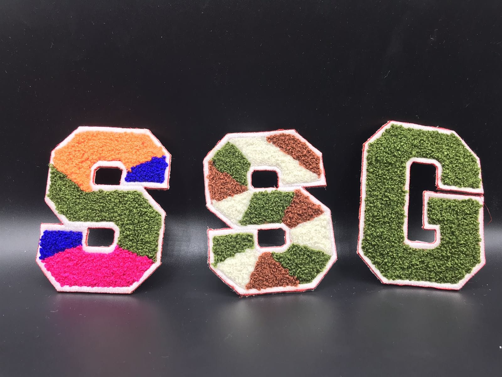Custom chenille patches displayed as premium branded apparel details
